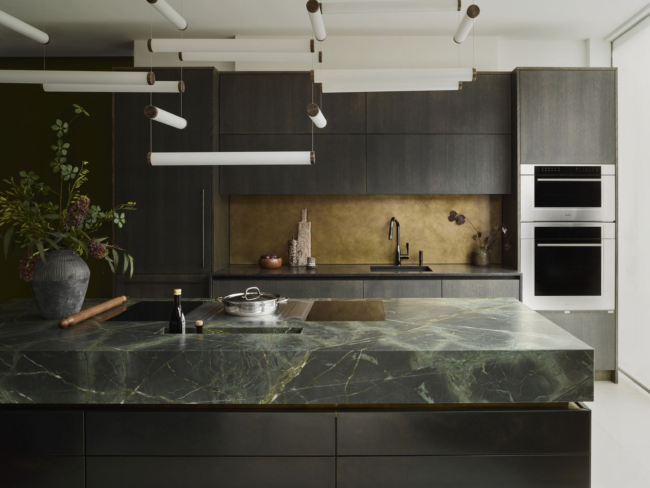 This kitchen has a green colored marble on the countertop