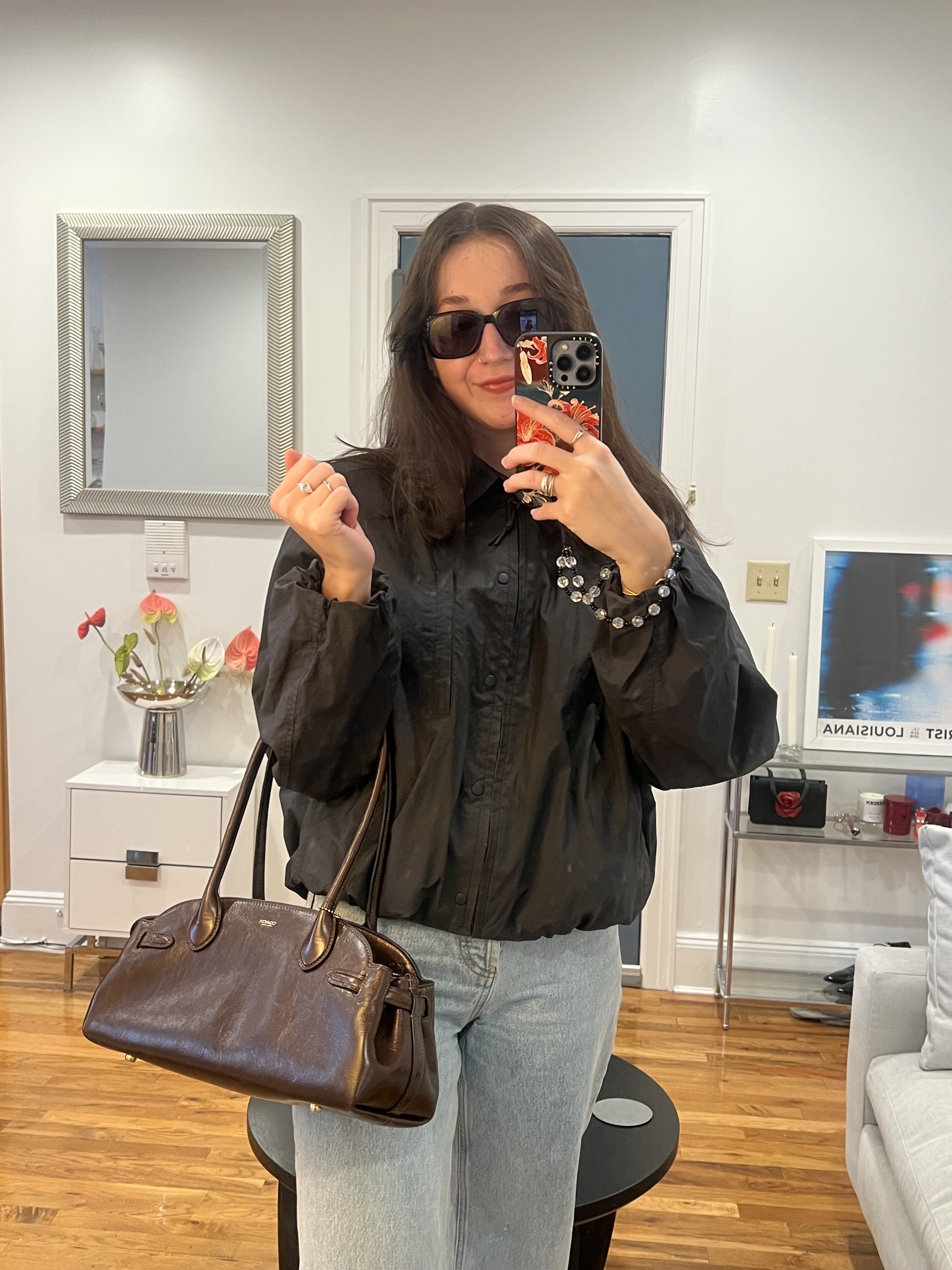 Fashion features editor Emma Childs carrying the Coach 34 Leather Carryall Bag in brown leather.