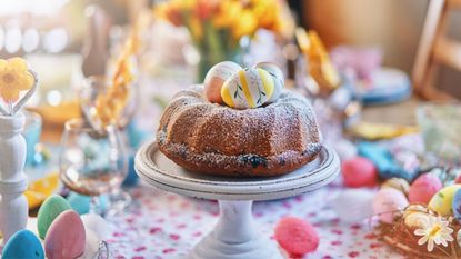 Easter decorations on table with cake in foreground