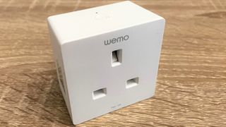 Belkin Wemo WiFi Smart Plug shown on wooden table