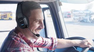 Man wearing Tecknet Trucker Bluetooth headset.