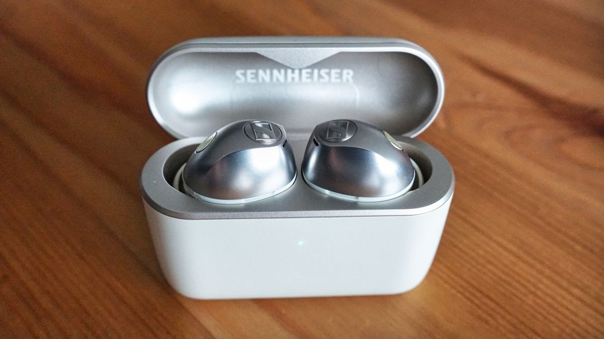 Sennheiser Momentum True Wireless 5 in white, showing details of the buds held in a hand