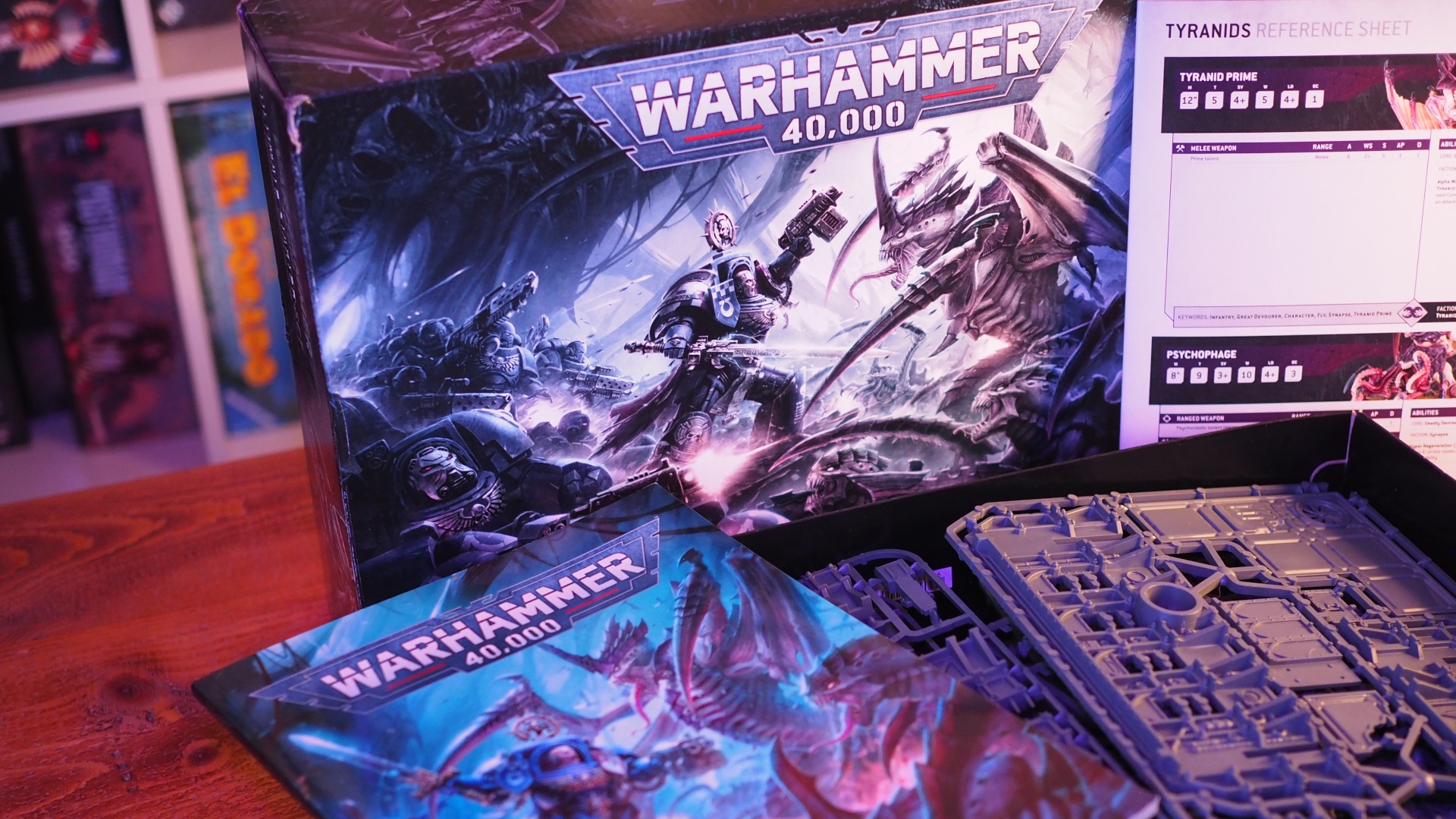 The Warhammer 40,000: Ultimate Starter Set box and contents on a wooden table