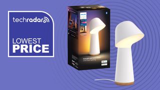 Philips Hue Twilight lamp and box on purple background with white text reading 'TechRadar lowest price'