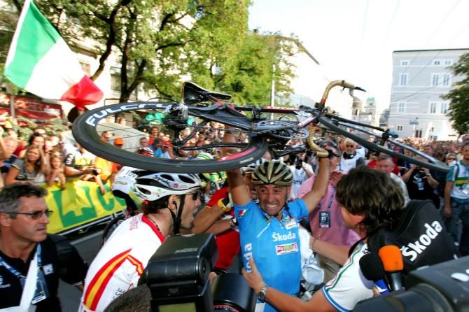 Paolo Bettini (Italy) celebrates his 2006 Worlds win by lifting his bike over his head as Alejandro Valverde tries to offer his congratulations