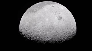 a grey, crater-marked orb on a black background