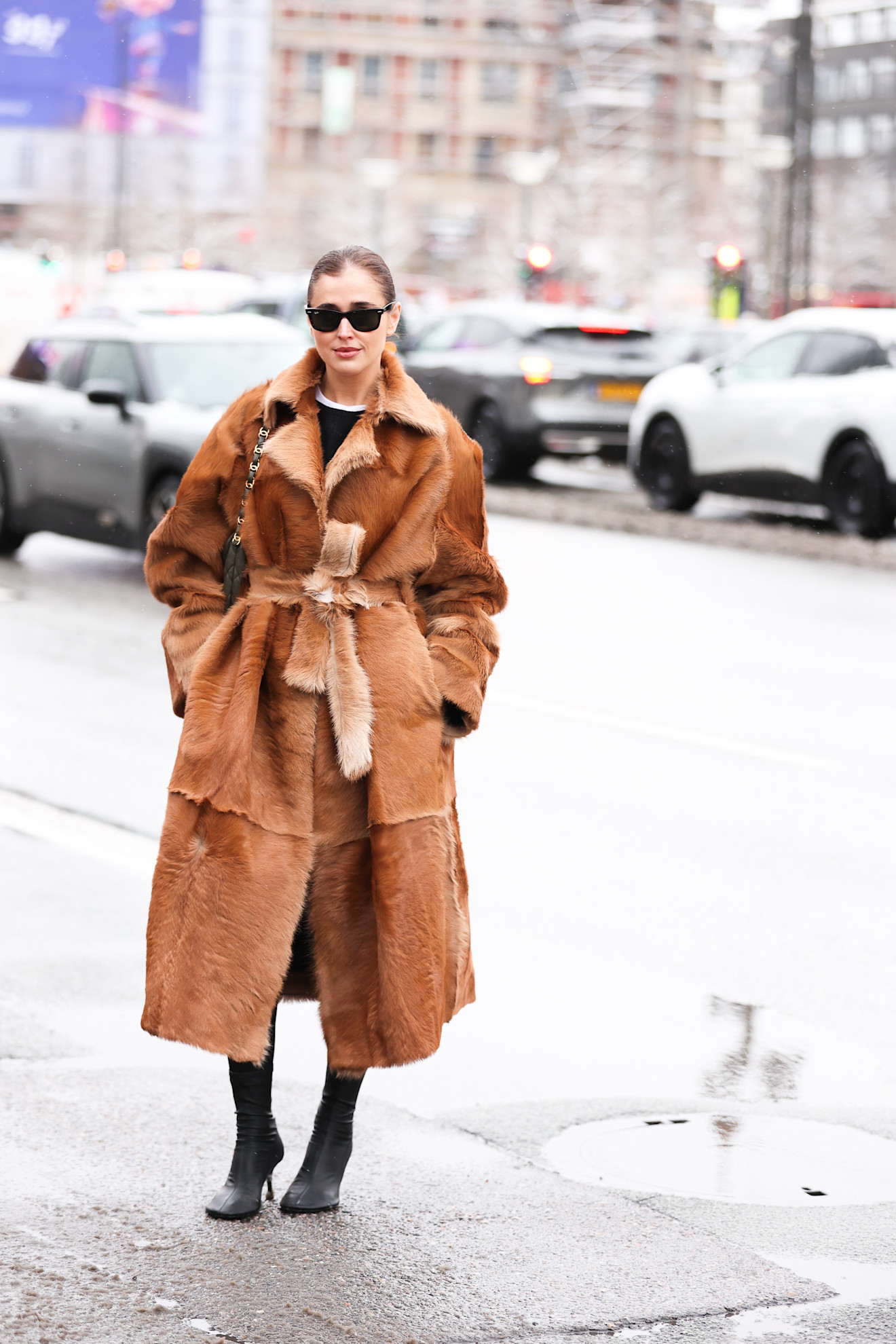 woman wearing a fur coat and long black boots in Copenhagen