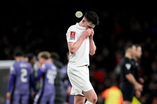 Declan Rice of Arsenal looks dejected after the team's defeat in the Emirates FA Cup Third Round match between Arsenal and Liverpool at Emirates Stadium on January 07, 2024 in London, England. Arsenal wear an all-white kit at home, for the first time in the club's history, in support of the 'No More Red' campaign against knife crime and youth violence.