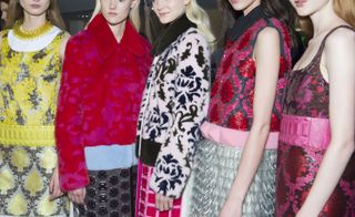 Models lined up in bright patterned clothing