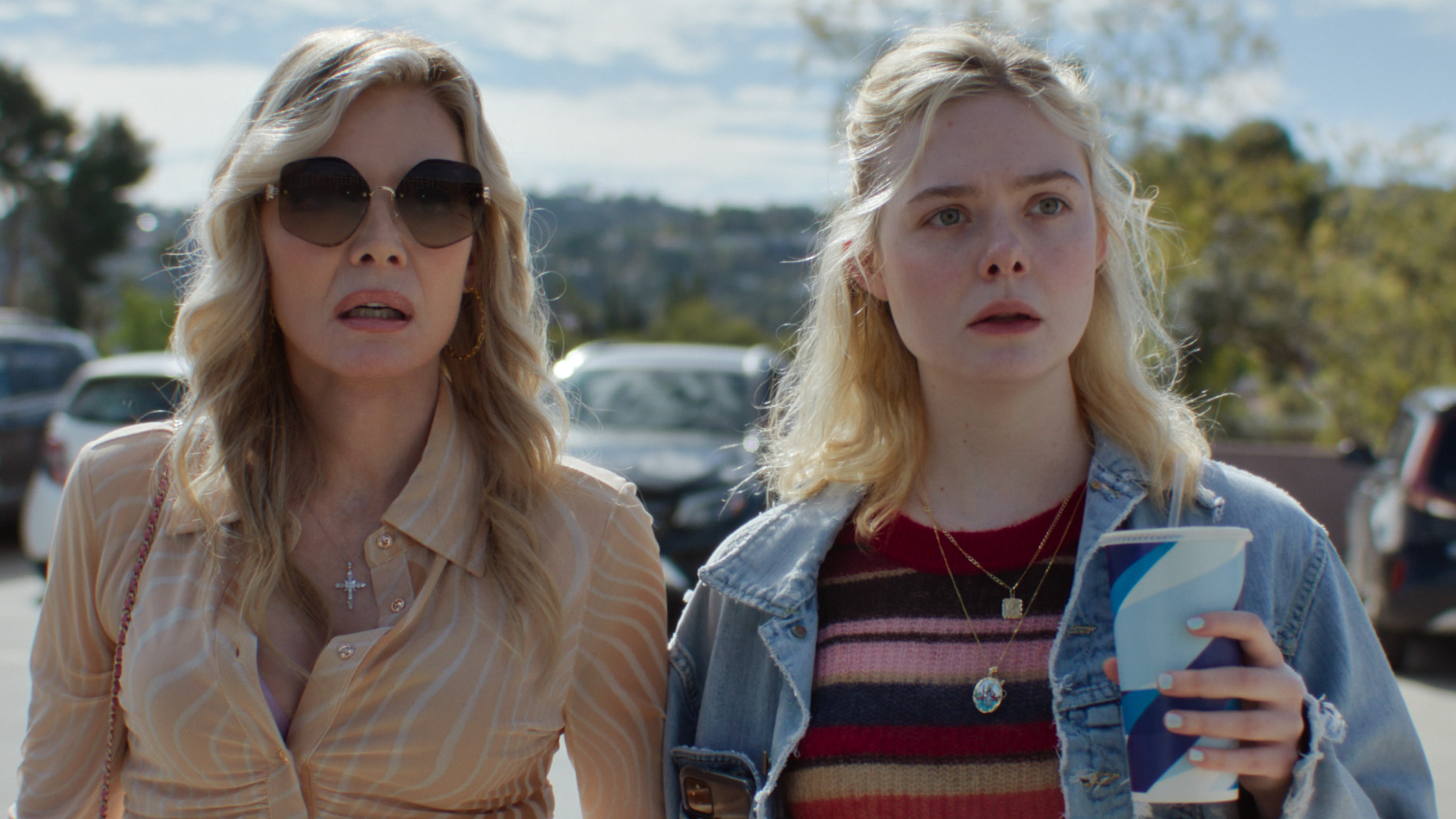 L-R: Shyanne (Michelle Pfeiffer) and Margo (Elle Fanning) in a car park in a scene from Apple TV's &amp;quot;Margo's Got Money Troubles&amp;quot;