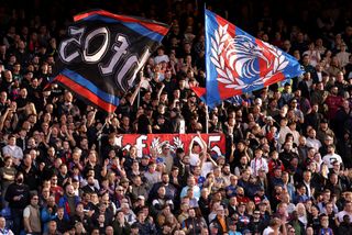 LONDON, ENGLAND - OCTOBER 27: Fans of Crystal Palace wave flags as they enjoy the match atmosphere during the Premier League match between Crystal Palace FC and Tottenham Hotspur FC at Selhurst Park on October 27, 2024 in London, England. (Photo by Warren Little/Getty Images)