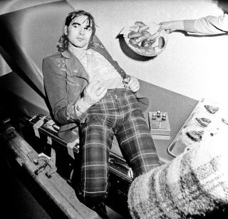 On the road again: Wood on the Traffic tour bus in March 1973
