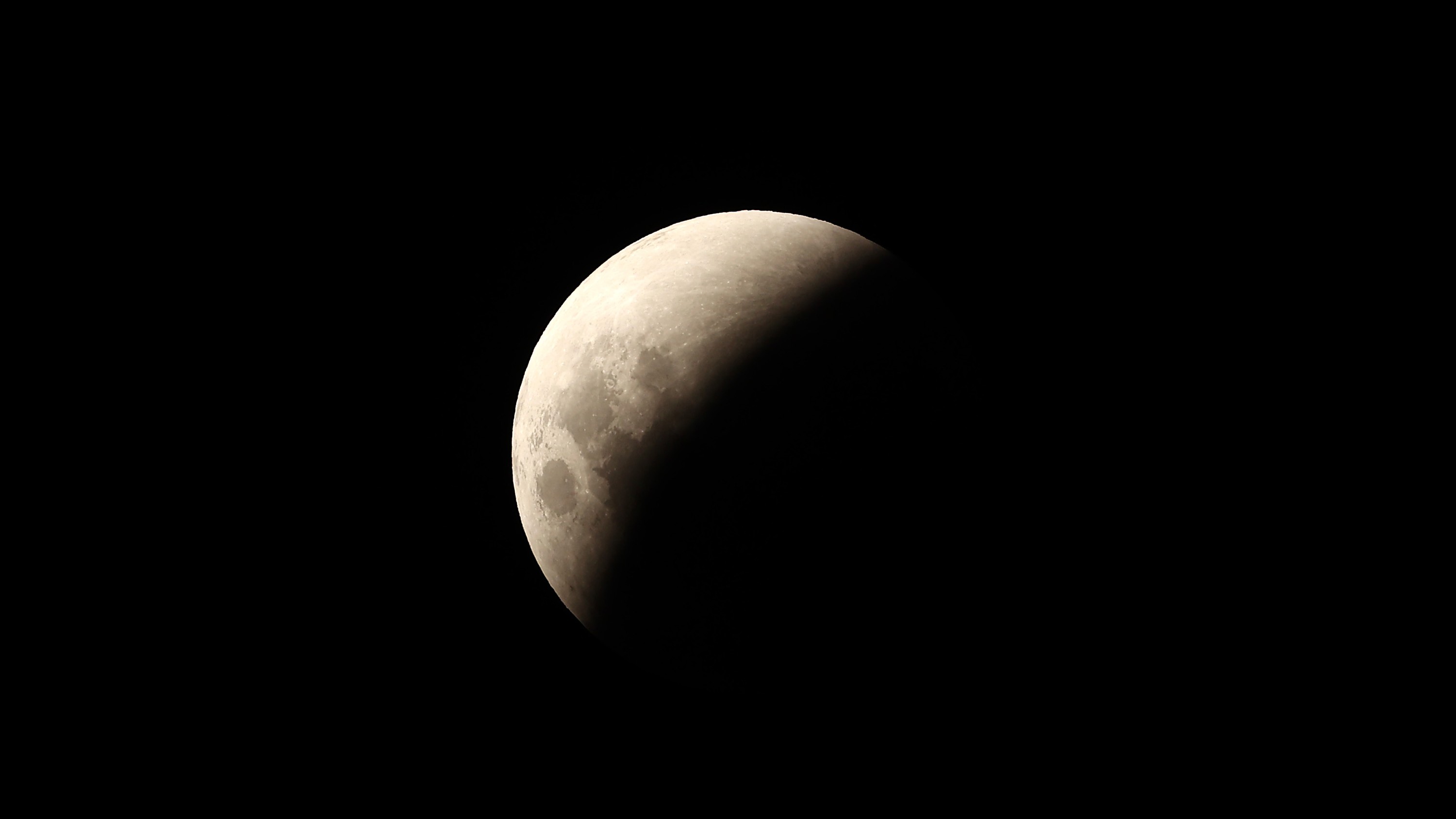 half illuminated lunar disk during lunar eclipse