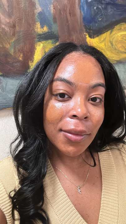 A girl in a tan shirt before applying spf.