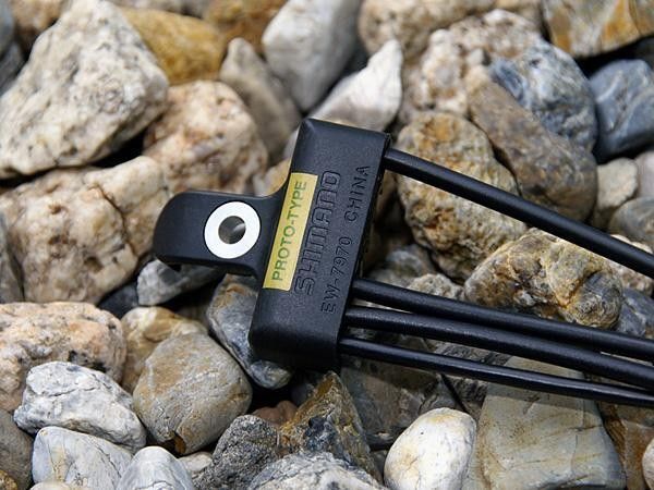 This little widget replaces the standard bottom bracket cable guide and serves as a junction point for the incoming and outgoing wires.