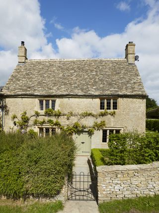 exterior house cotswold stone hedge with vines