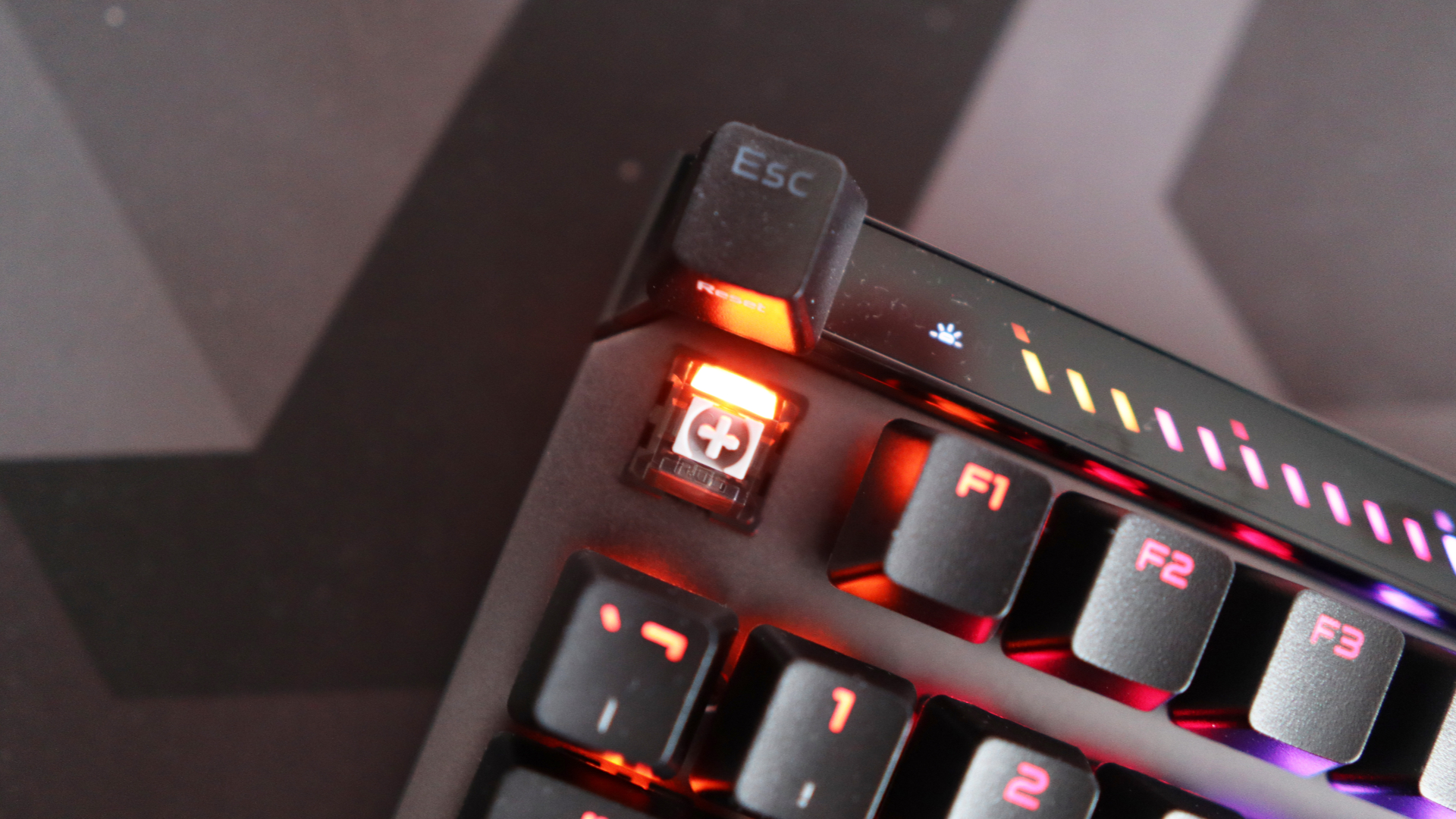 The Asus ROG Falchion Ace 75 HE on a desk with the lighting enabled.