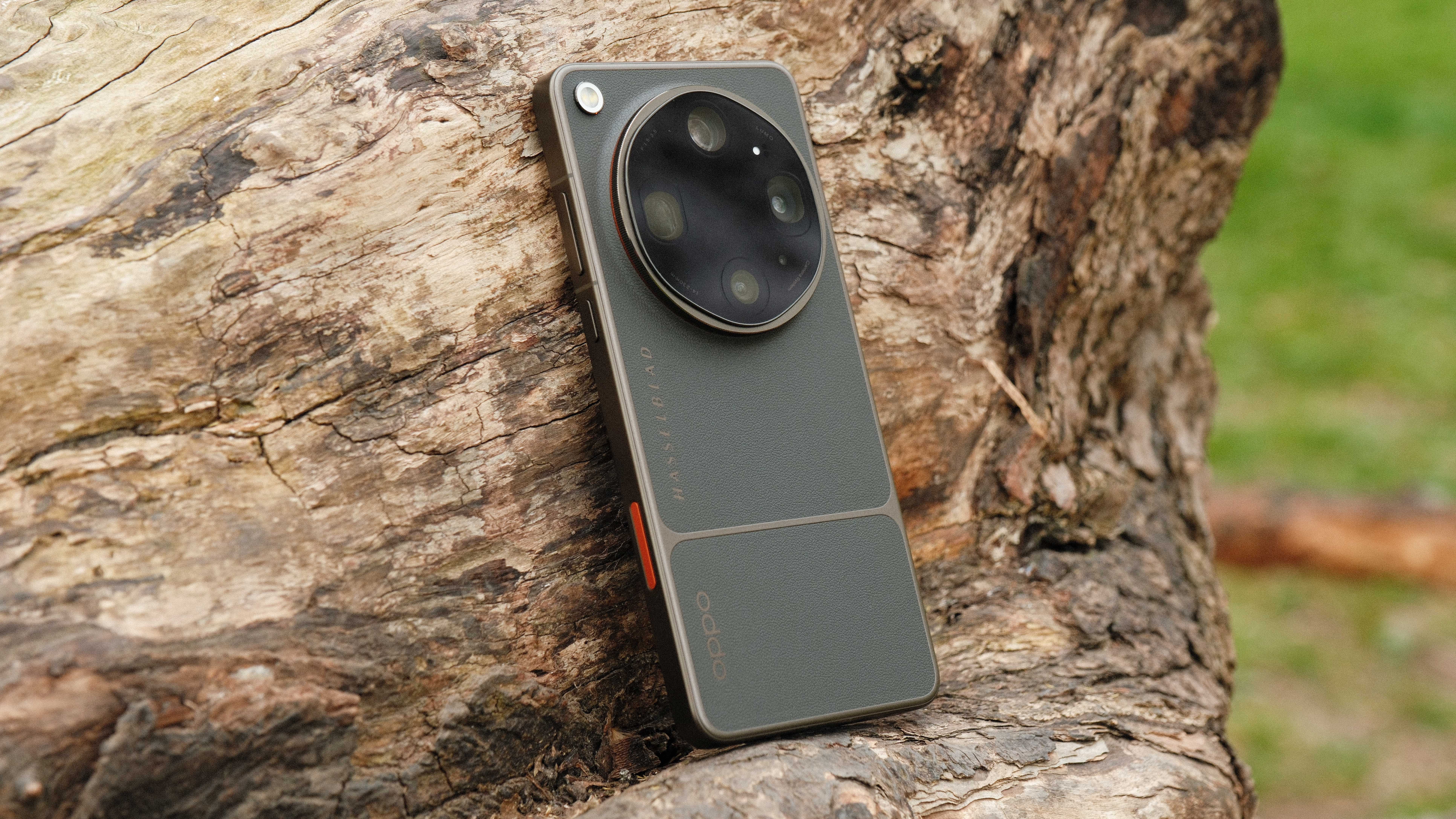 Oppo Find X9 Ultra leaning against a tree trunk outdoors
