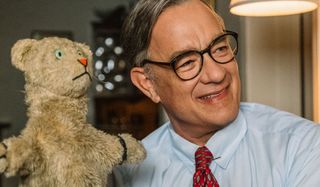 A Beautiful Day In The Neighborhood Mister Rogers poses with Daniel Tiger