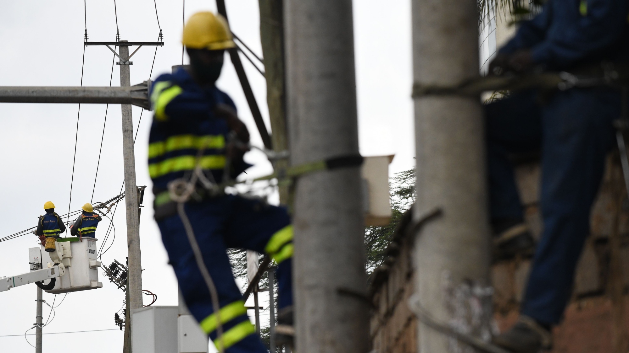 Kenya Power and Lighting Company (KPLC) live line experts use an articulated lift to relocate power lines to pave way for the construction of the Nairobi Expressway in Westlands, Nairobi