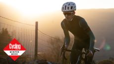 Image shows a cyclist riding through the winter.