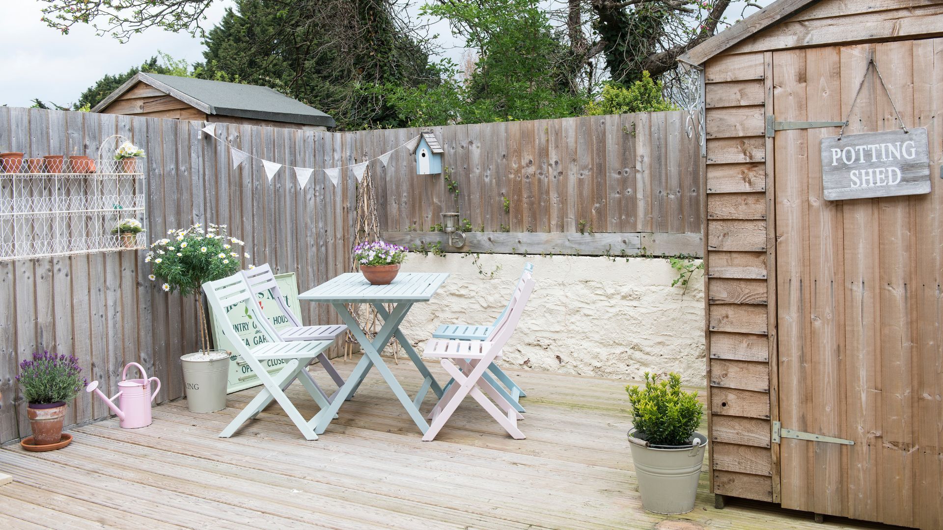 picture of garden with decking, patio set and shed