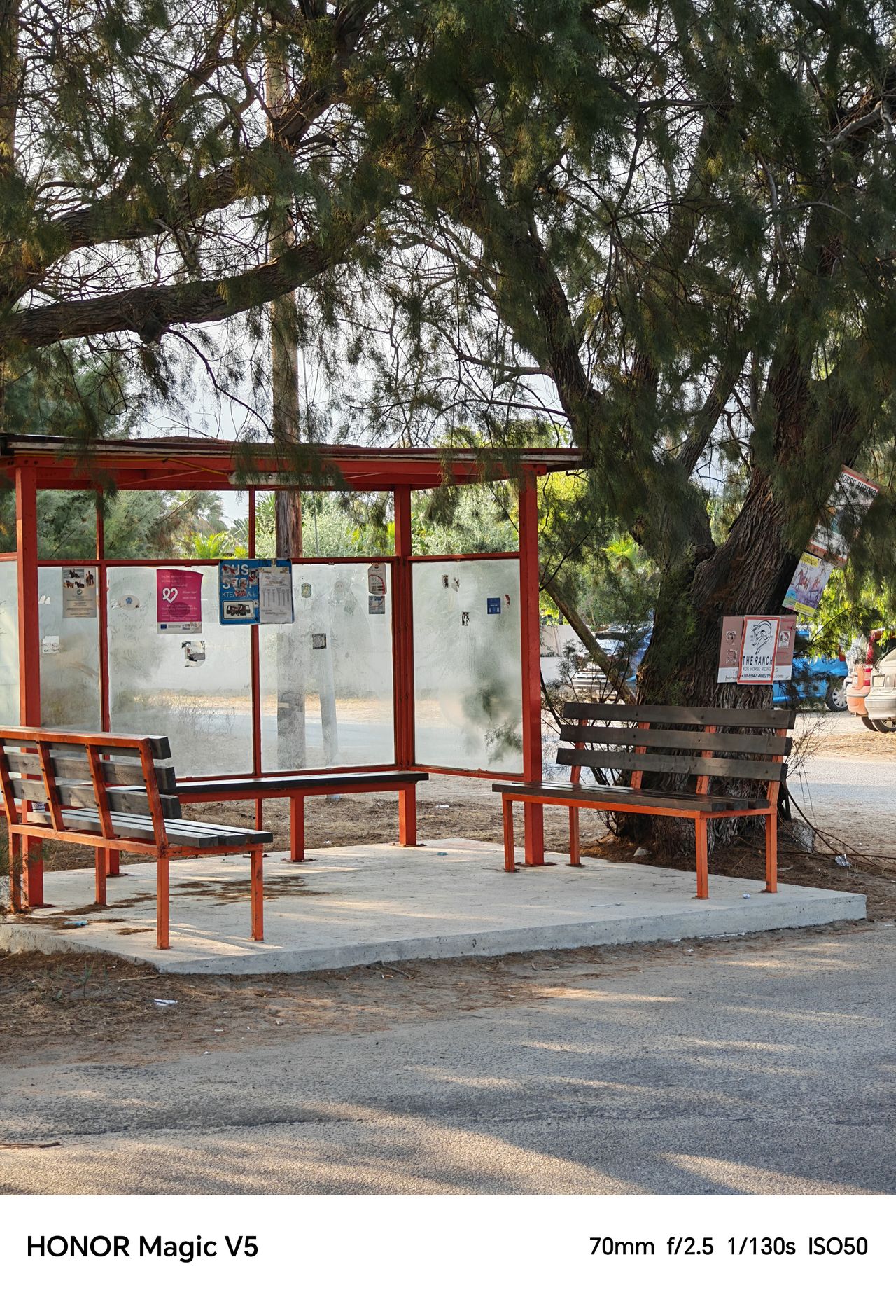 A bus stop with wooden benches