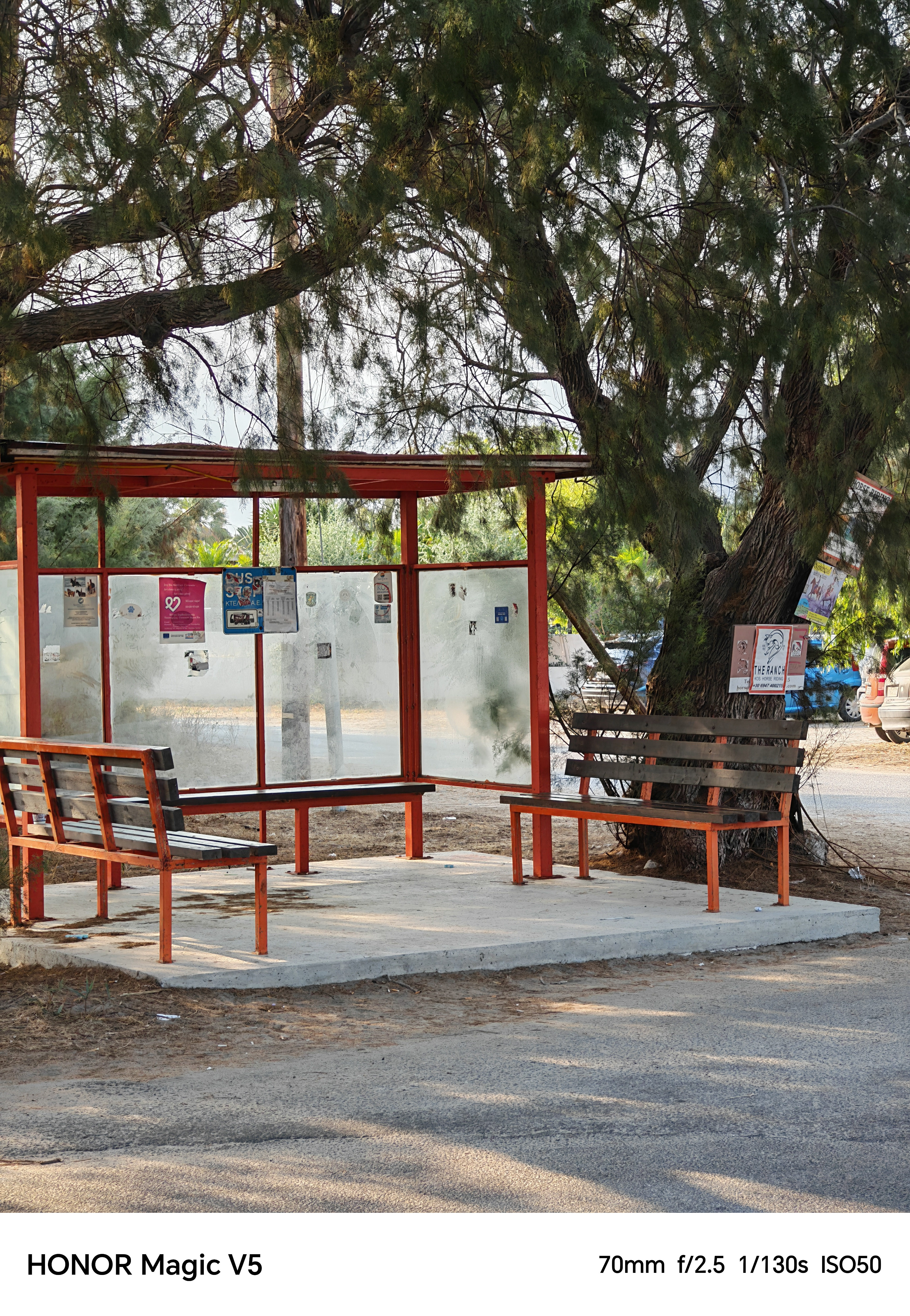 A bus stop with wooden benches