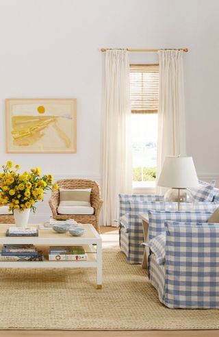 Bright, coastal living room with blue checked chairs, coffee table