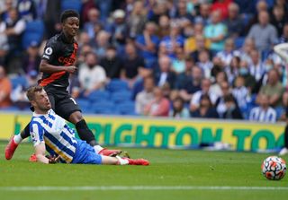 Everton’s Demarai Gray (top) scores his sides first goal of the game past Brighton and Hove Albion’s Adam Webster during the Premier League match at Amex Stadium, Brighton. Picture date: Saturday August 28, 2021