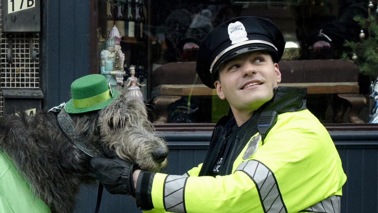 Sean Reagan (Mika Amonsen) pets Guinness the dog on Boston Blue.