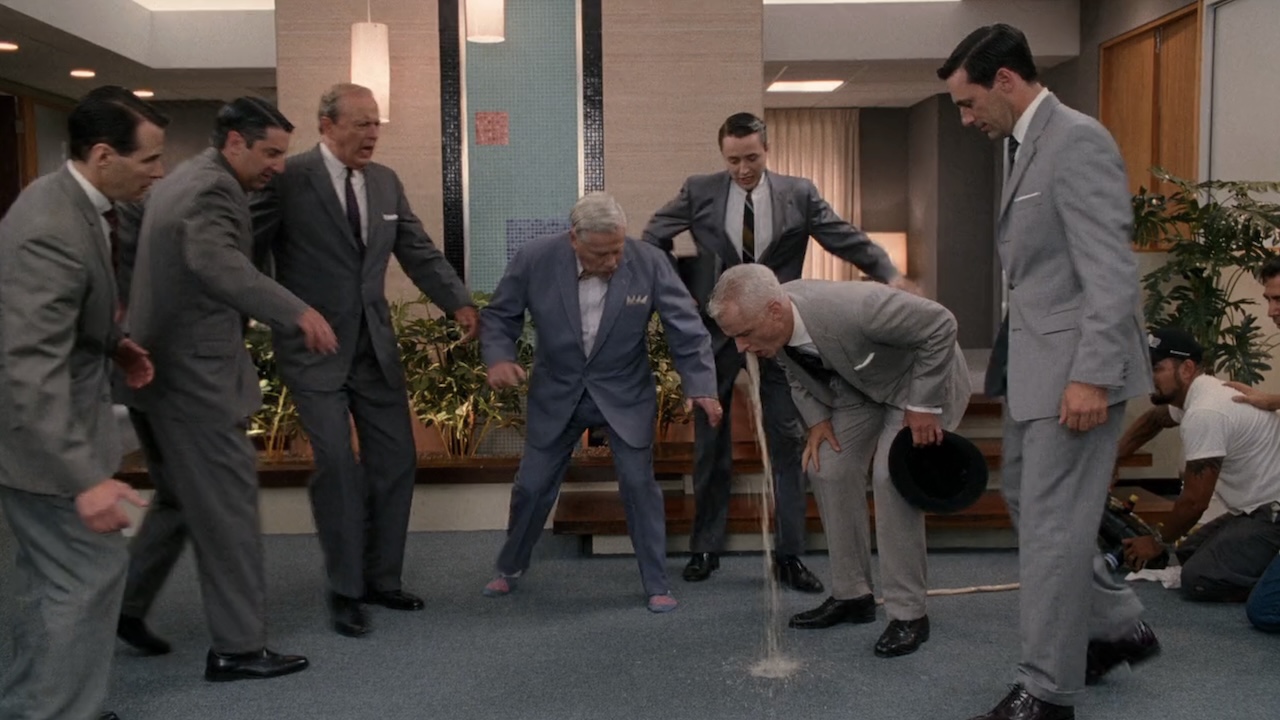 Roger Sterling throwing up in front of Don Draper, Pete Campbell and Nixon officials in Mad Men, all while a crew member is seen operating the fake vomit machine