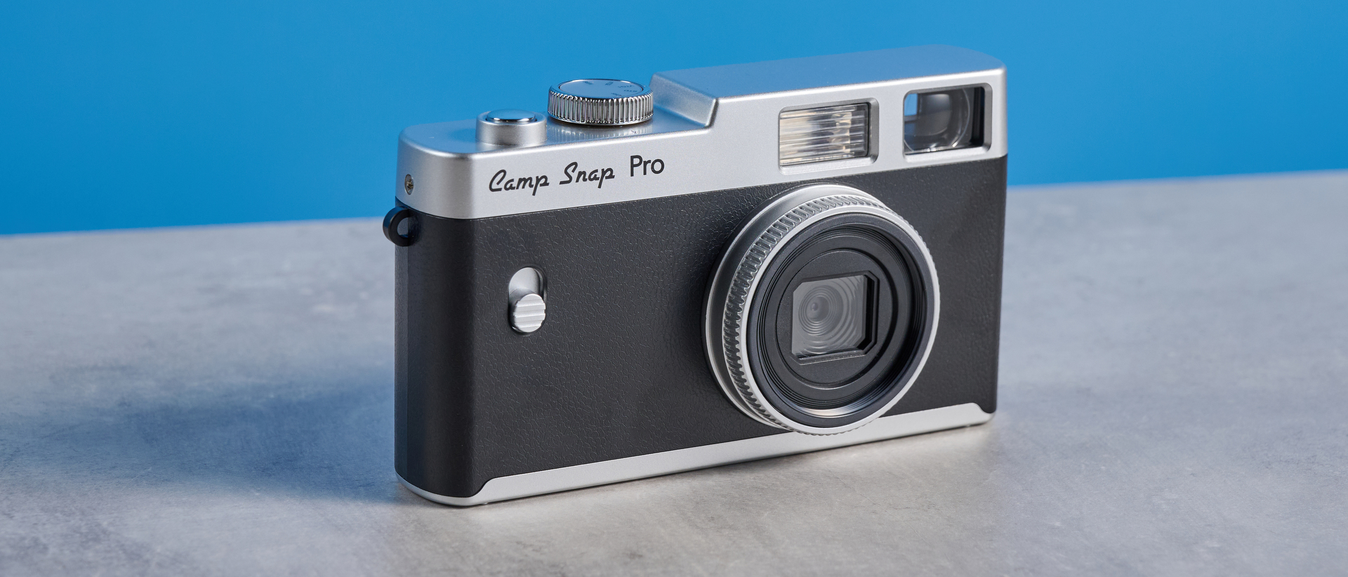 Camp Snap CS-Pro in black and silver photographed on a blue background