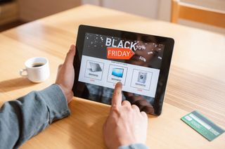 A person using a tablet to browse Black Friday deals.