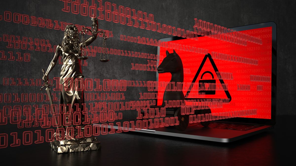 Trojan horse on a red laptop screen with blind justice in front of it