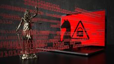 Trojan horse on a red laptop screen with blind justice in front of it
