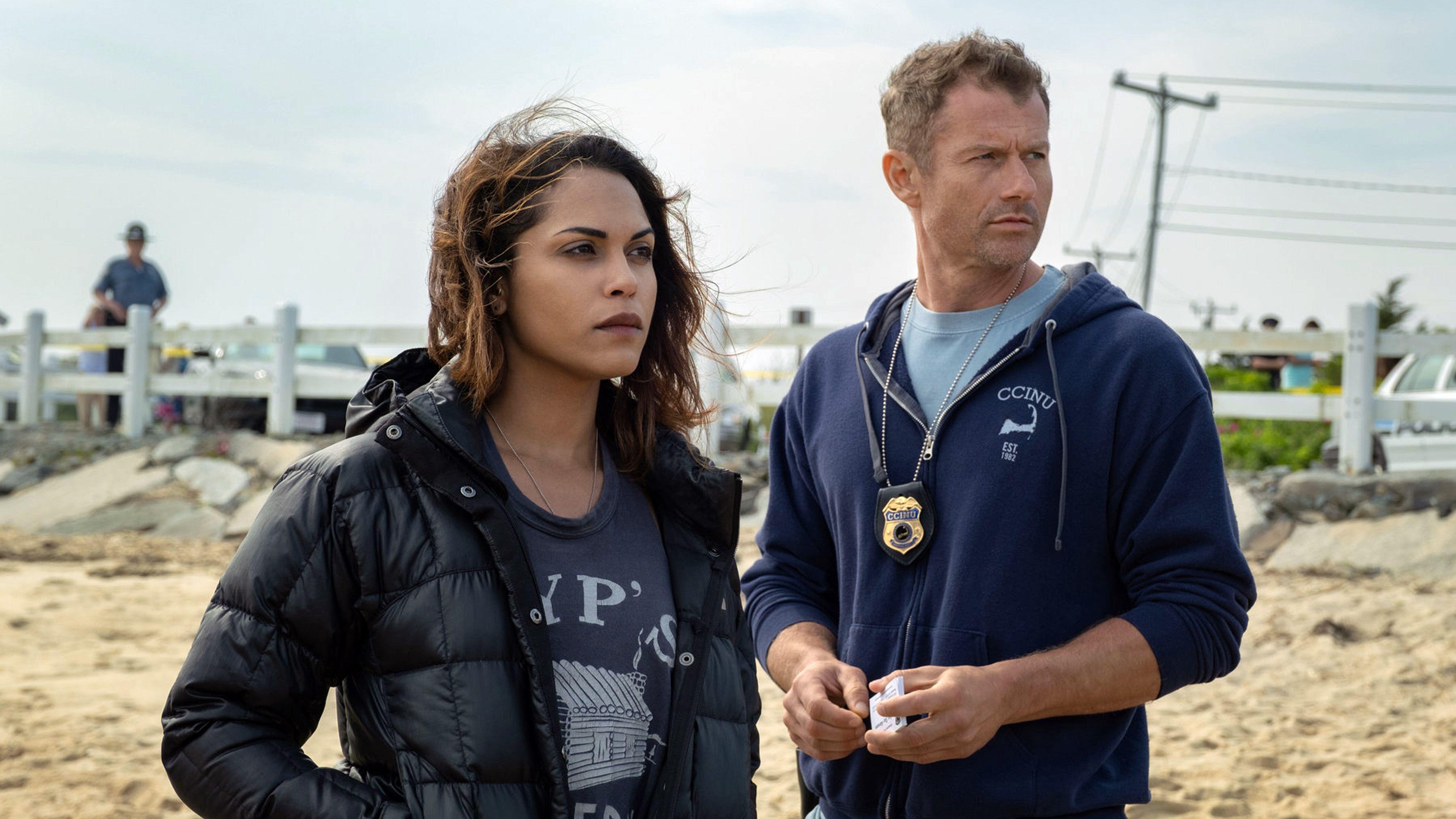 L-R: Monica Raymund, James Badge Dale stand on a beach in a scene from Starz crime drama, "Hightown"