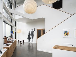 The Eames Institute of Infinite Curiosity Bay area headquarters and archive interior showing white staircase
