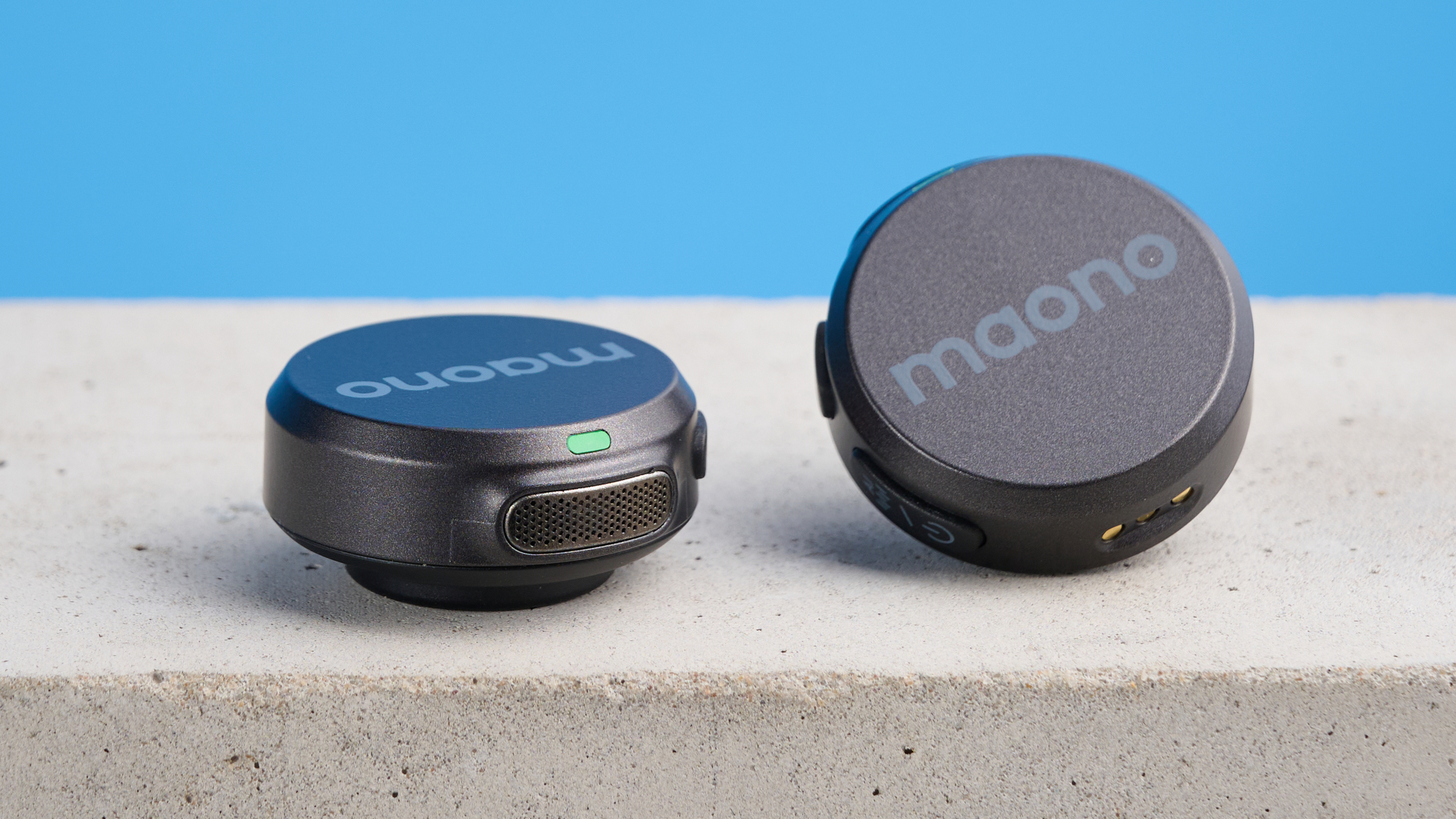 the maono wave t5 lavalier microphone shown against a blue background, showing the transmitters, receivers, and charging case