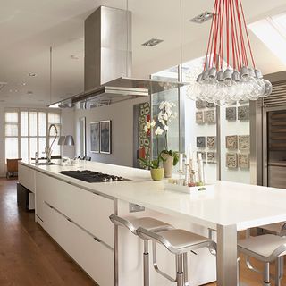 contemporary kitchen with hanging light and stainless steel bar stool