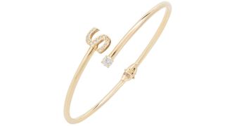 A gold initial bangle, one of the best personalized jewelry gifts.