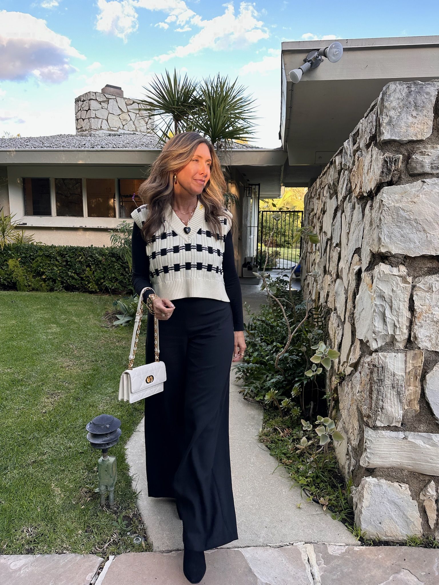 Melissa Meyers wears a sweater vest from Revolve L'Academie