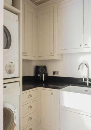 stacked appliances in small cream utility room