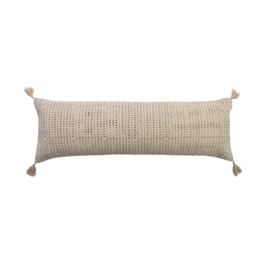 A bolster cushion with tassles