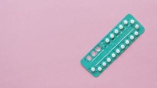 birth control pills on a pink background