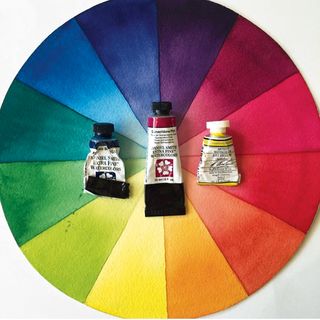 Painted colour wheel with tubes of paint on top