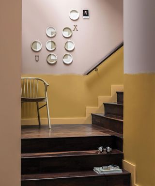 painted hallway with mustard yellow lower half and pale pink upper half