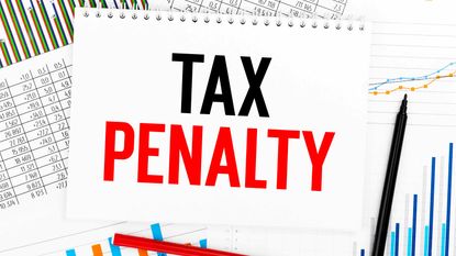 picture of a notebook with "tax penalty" written on it