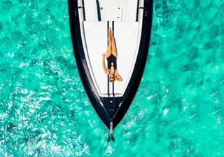 A woman relaxes on a yacht on Nassau Paradise Island