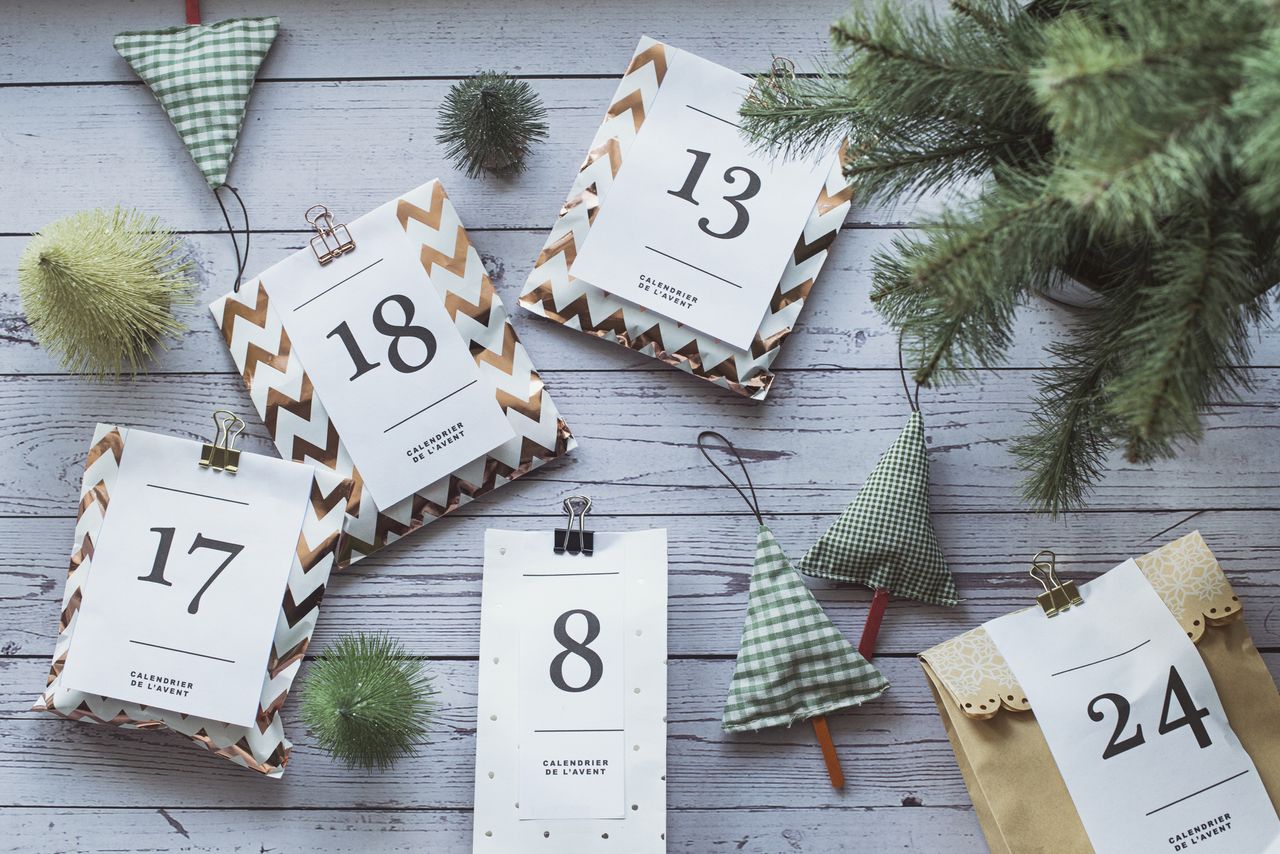 Christmas parcels labelled with days of month next to small christmas tree